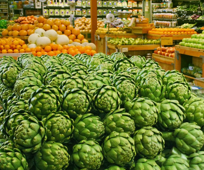 Bin of artichokes in grocery store